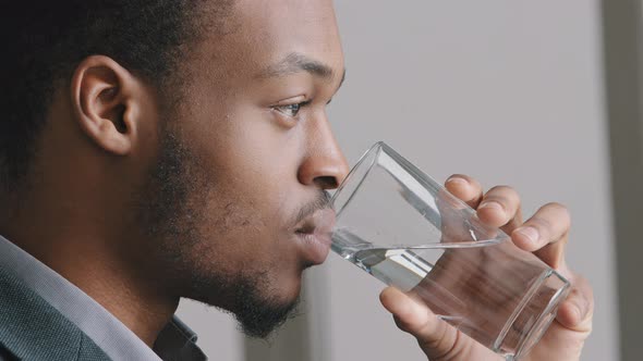 Calm Handsome African American Guy Ethnicity Man Holding Glass of Mineral Natural Clean Water Make