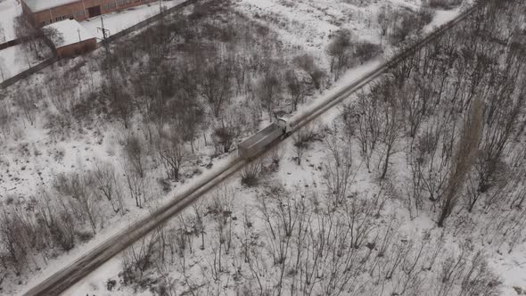 Aerial View Construction Truck Is Driving On A Winter Road