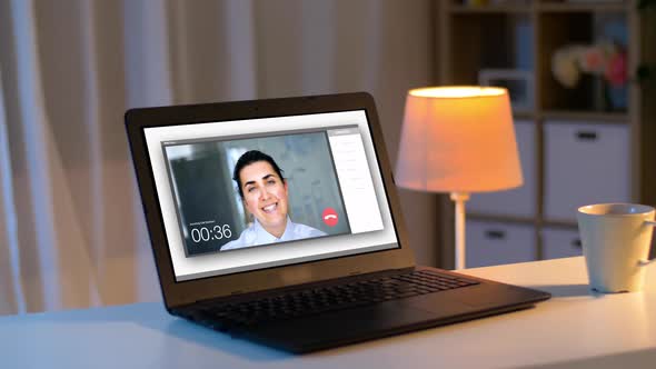 Laptop with Video Call on Screen on Table at Night 114