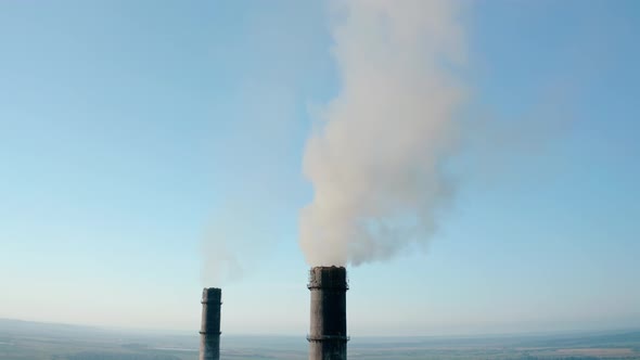 Aerial Drone View of High Chimney Two Pipes with Grey Smoke From Coal Power Plant. Close Up