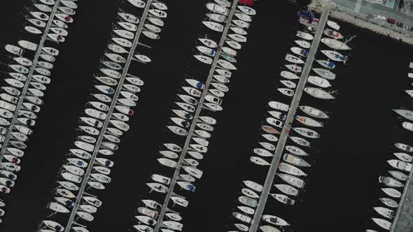 Aerial Drone Flying Out Over a Marina for Boats and Tourist Ships