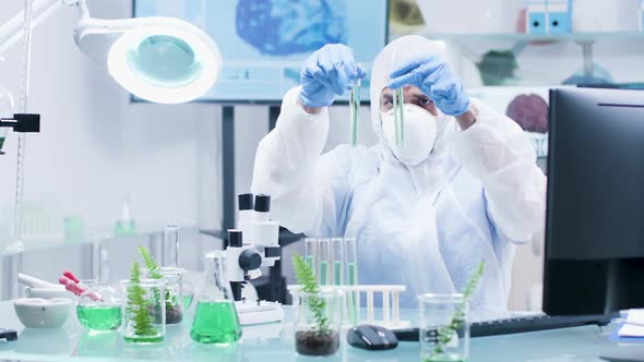 GMO Researcher Looking at Tubes with Sample