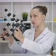 Female Researcher Looks at Molecule Model in Lab Developing New Natural Cosmetic - VideoHive Item for Sale