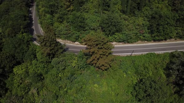 Aerial View From Above of Curve Road with a Car on the Mountain with Green Forest in Russia