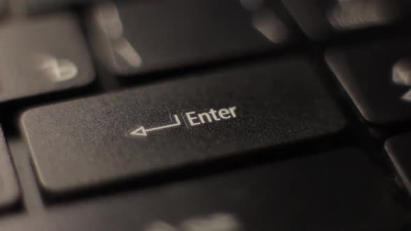 The Finger Presses the Enter Button on the Keyboard. Close-up.