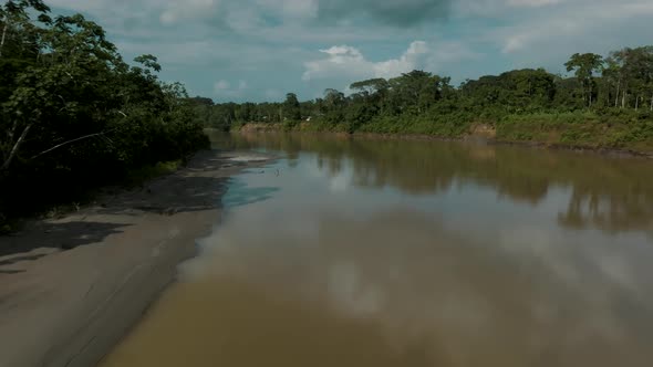 Flying Over Calm River In The Amazon Jungle With Dense Thicket On Summertime. Aerial Drone Shot