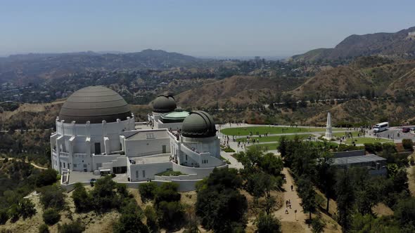Aerial video orbiting the Griffith Observatory with the Hollywood sign and some of Los Angeles in th