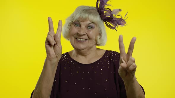 V Sign, Peace. Happy Senior Old Woman Showing Victory Sign with Double Fingers and Smiling