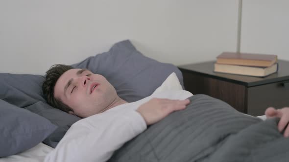 Man Waking Up From Nightmare in Bed