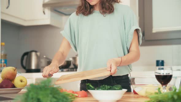 Close Up Shot of Two Young Pretty Women Cooking in the Bright Kitchen.