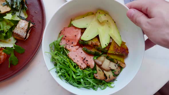 Salmon Salad with Avocado Zucchini Top View Hand Rotating