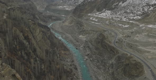 Hunza Nagar valley. cloudy sky in Karakoram range, with a view of Hunza river and forest trees in au