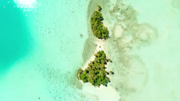 Aerial: flying over coral reef tropical islands caribbean sea turquoise blue water, Indonesia