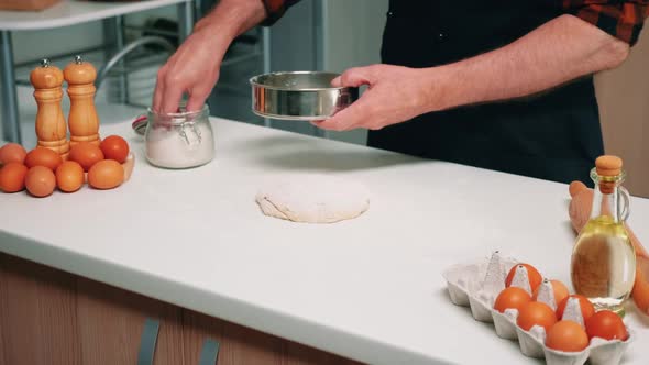 Man Sifting Flour with Sieve