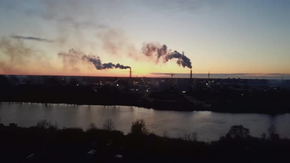 Smoking Stack in Sunrise. Air Pollution and Climate Change Theme. Poor Environment in the City