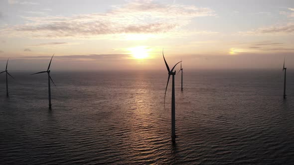 Offshore Windmill Park with Clouds and a Blue Sky Windmill Park in the Ocean Drone Aerial View with