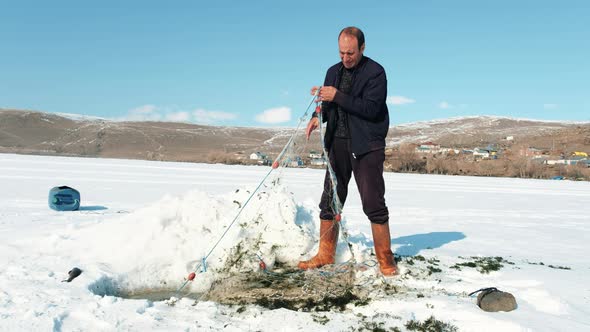 Man Fishing in Snowy Region