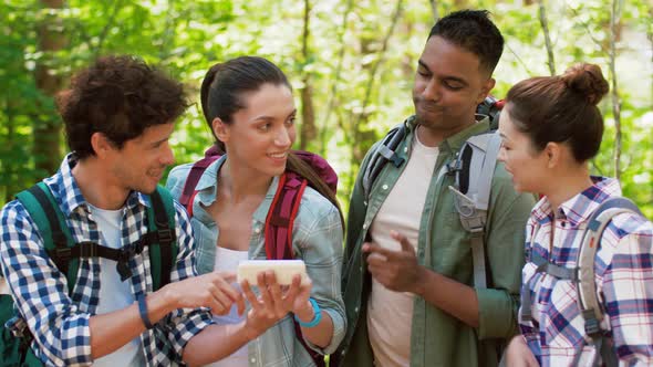 Hiking Friends with Backpacks and Smartphone