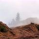 Waves of Mist Spill Over a Grassy Mountain Hill - VideoHive Item for Sale