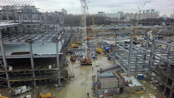 Aerial View of Construction Site with Unfinished Steel Frame Buildings alt
