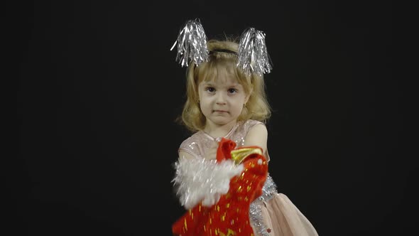 Happy Beautiful Little Baby Girl in Glossy Dress. Christmas. Make Faces, Dance