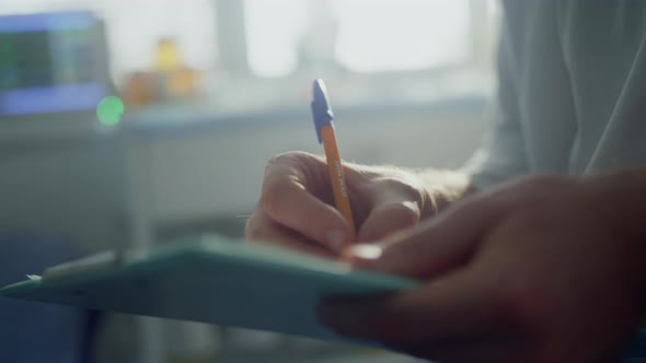 Doctor Hands Filling Patient Registration Form Close Up