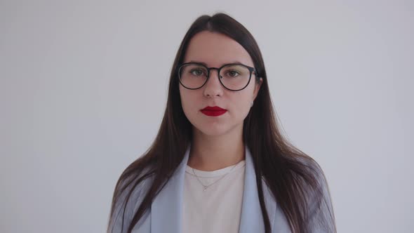 Portrait of a Confident and Serious Business Lady in Glasses on an Isolated White Background