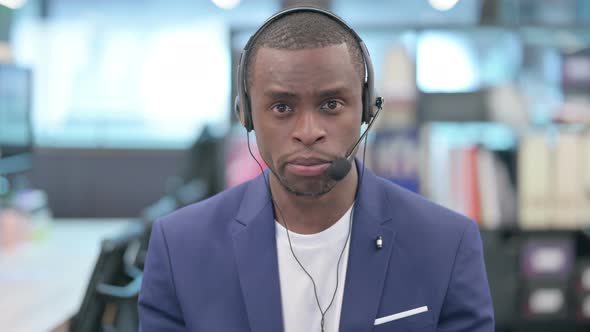 Portrait of African Businessman Talking with Headset