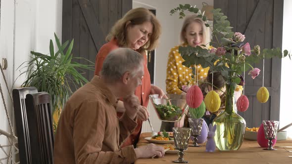 Family at Easter dinner sitting at the table at home