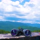 Hiking Sticks And Binoculars On The Wooden Table, Mountain Valley On A Background - VideoHive Item for Sale