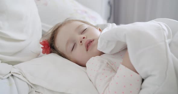 Adorable Oneyearold Girl Sleeping Peacefully in the White Bedroom