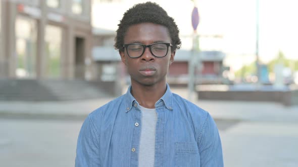 Young African Man Looking at the Camera Outdoor