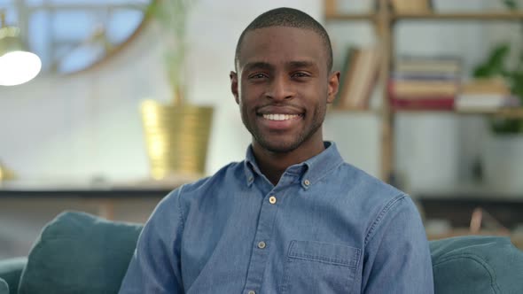 Young African Man Smiling at Camera at Home 