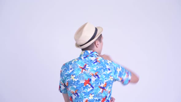 Rear View of Young Tourist Man Pointing Finger