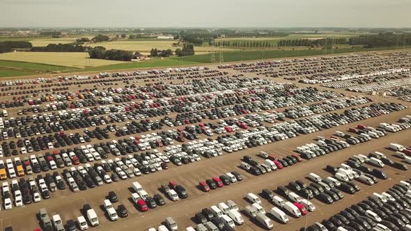 Many new and occasion Cars on a huge parking lot waiting for shipment, Aerial