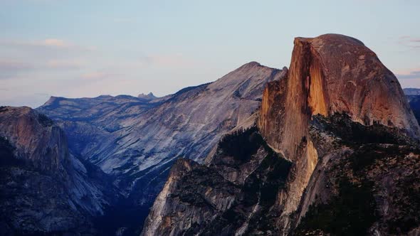 sunset panning shot of half dome at yosemite recorded from glacier point