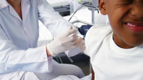 Doctor giving an injection to a boy