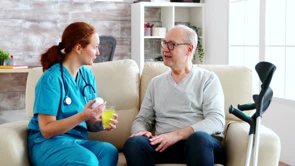 In Retirement Home Nurse Is Giving Daily Pills To Old Man