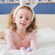 Cute Funny Girl Baby with Bunny Ears and Colorful Easter Eggs at Home on a White Bed - VideoHive Item for Sale
