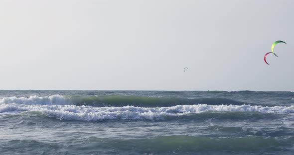 Surfers floating on the waves of the Mediterranean Sea
