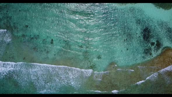 Aerial drone view panorama of tranquil seashore beach adventure by blue sea with bright sandy backgr