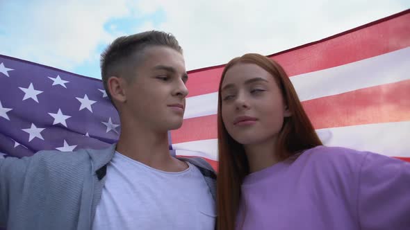 Teen Couple in Love Touching Foreheads Holding American Flag, Young Patriots