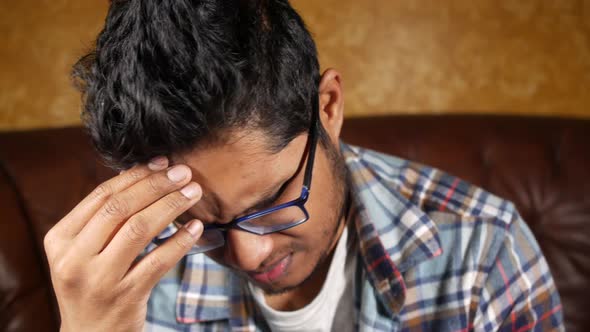 Young man suffering headache, close up 