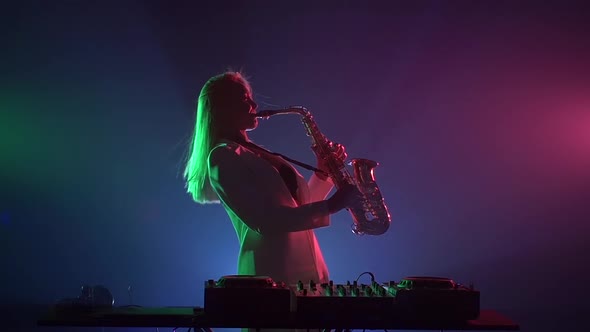 Young Sexy, Blonde Woman Dj, Bending, in White Jacket and Black Top Playing Music Using Saxophone