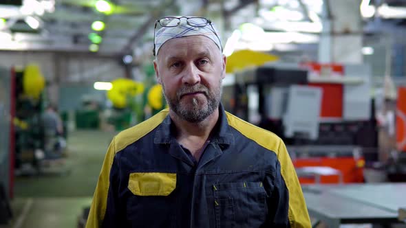 Portrait of Employee of Plant with a Serious Face