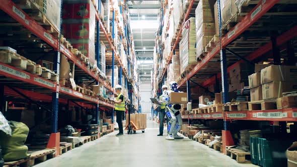 Male Engineer is Operating a Cyborg in the Warehouse