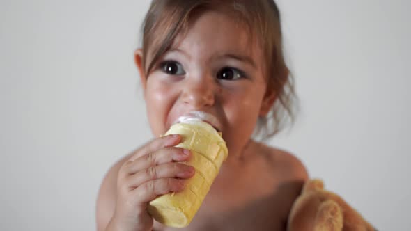 Child Toddler Girl with Ice Cream at Home. Tasty Yummy Sweet Food. Funny Face