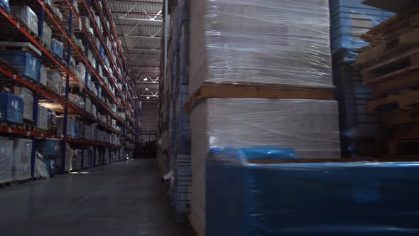 Panorama Between the Rows of a Huge Logistics Warehouse