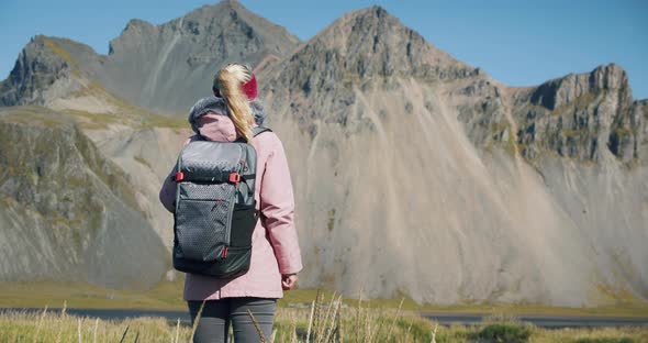 Rear View of Woman Discover Stokksnes Looking at Vestrahorn Mountain in the Background