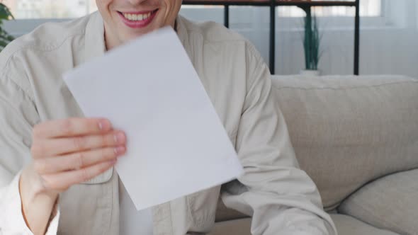 Smiling Happy Caucasian Man Millennial Guy Businessman Sitting Home Indoors Opens Envelope Reads